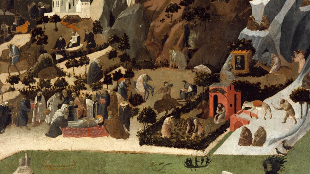 A medieval painting depicts a group of people in robes mourning around a figure lying on a red blanket, with others digging, praying, and walking in a hilly, rocky landscape dotted with trees and small buildings.