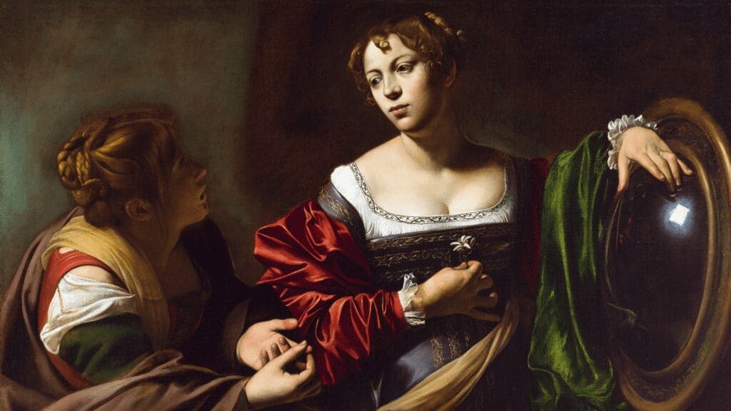 Two women in Renaissance-style clothing, one holding a mirror and gazing thoughtfully, while the other leans toward her, gesturing with her hands against a dark background.
