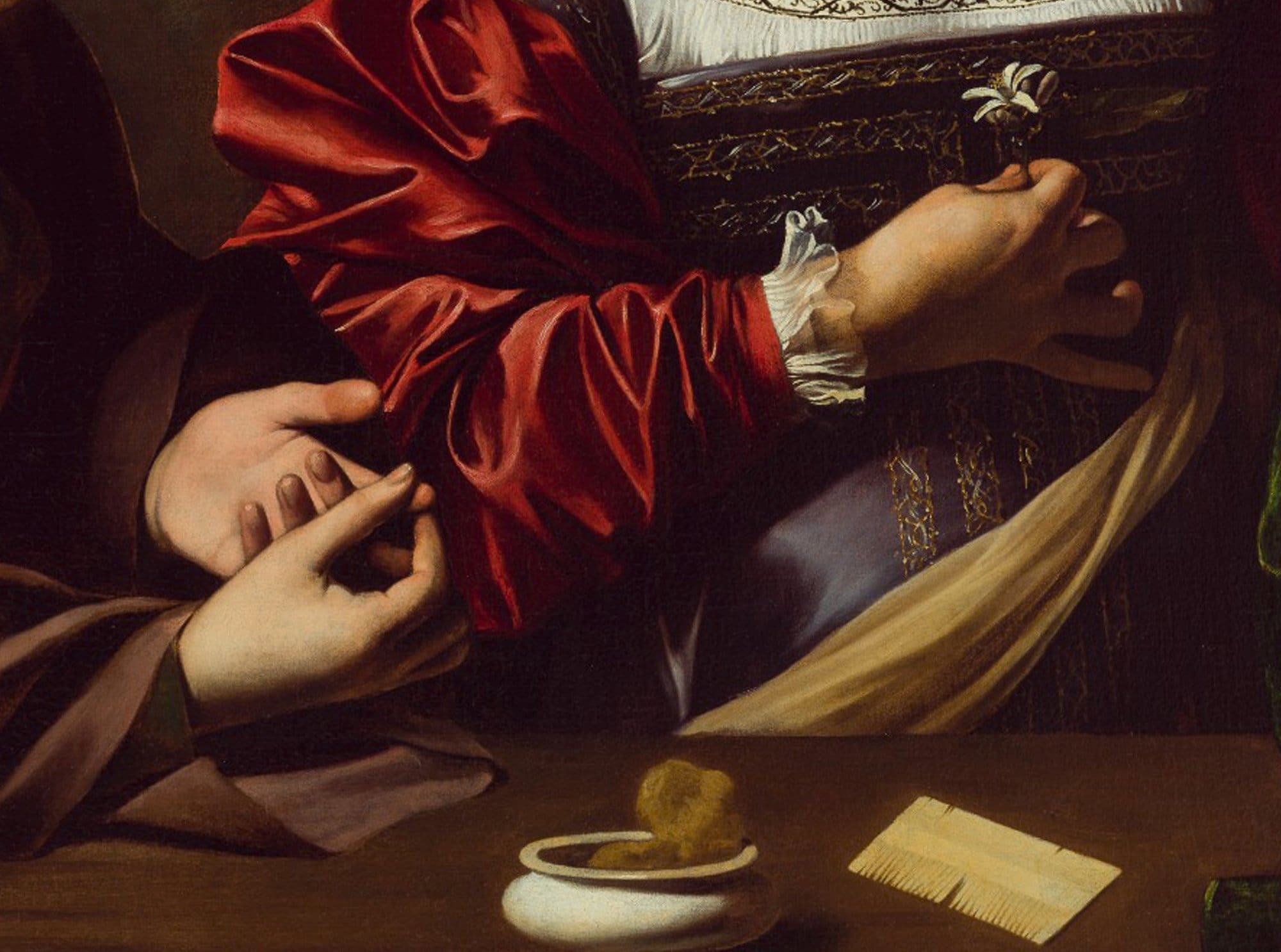 A close-up of two figures in Renaissance clothing: one holds their wrist while the other feels their pulse. There is a comb and a small dish on the table in front of them. The scene is detailed and richly colored.