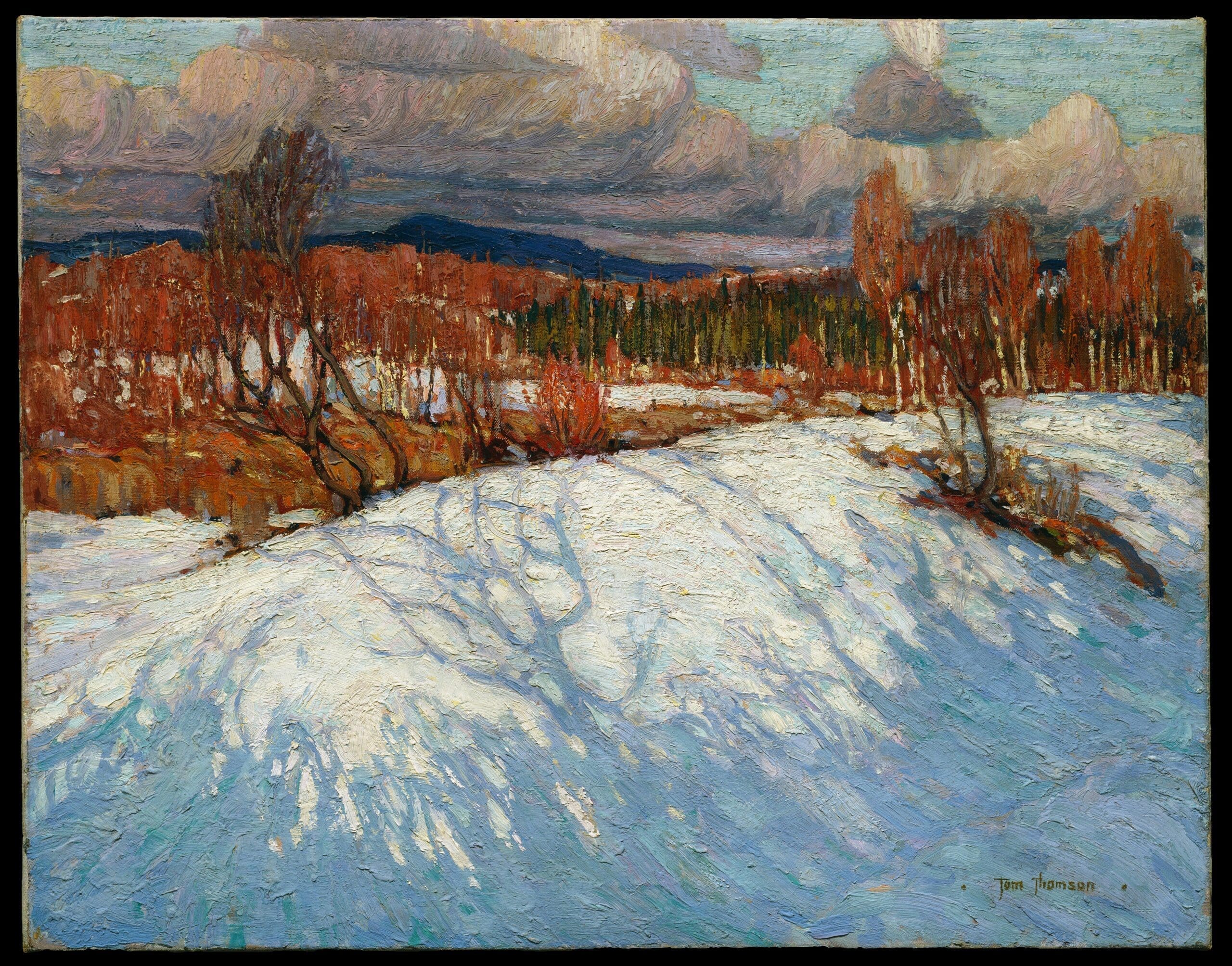 An impressionist winter landscape shows snow-covered ground, leafless trees with orange-brown branches, distant green pine trees, and blue mountains beneath a cloudy sky.