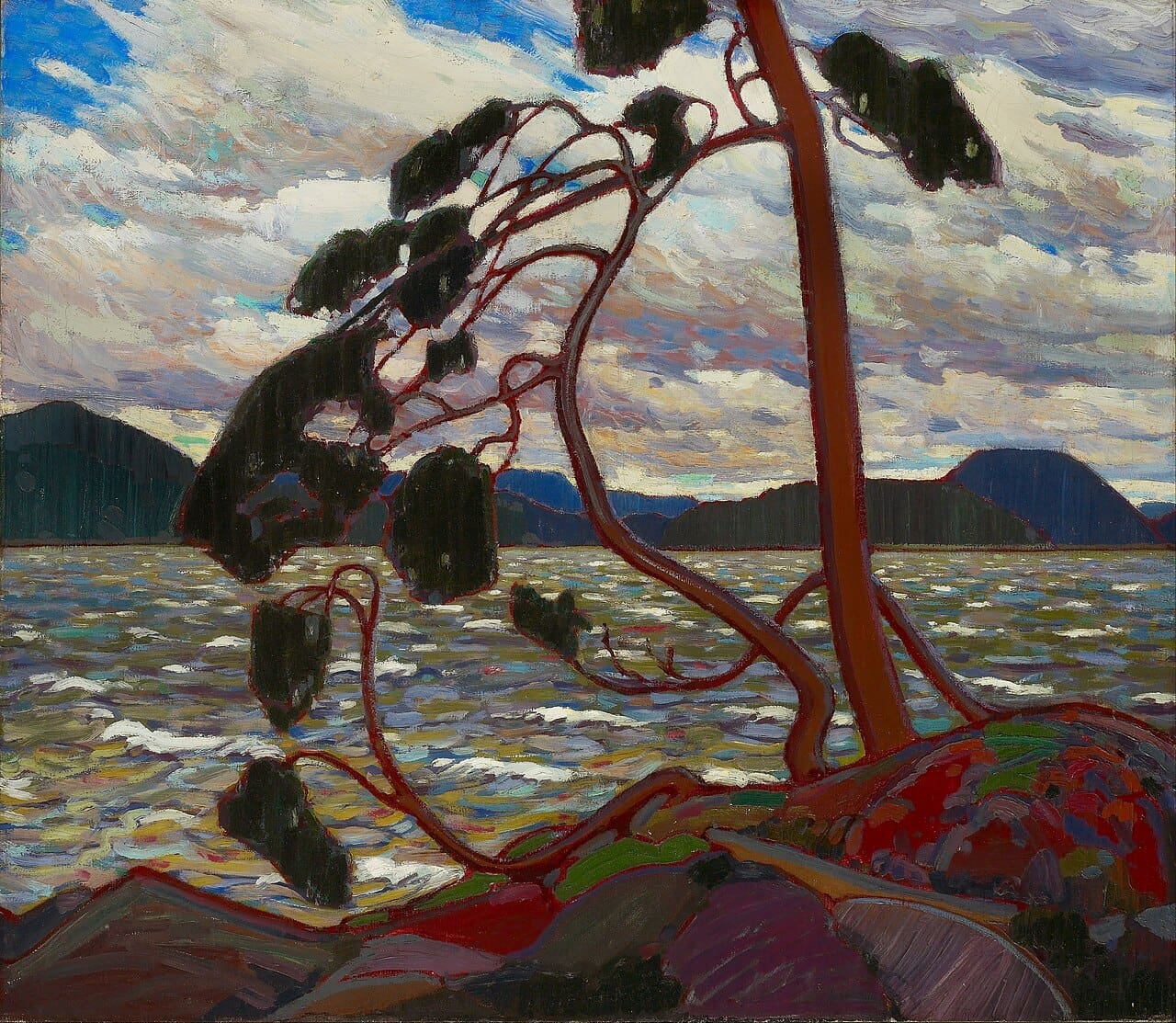 A wind-swept pine tree bends over rocky ground beside a choppy lake, with mountains and a cloudy sky in the background, painted in bold, colorful brushstrokes.